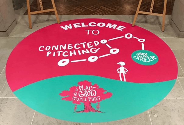 A floor graphic is printed onto the floor of a business, its bright colours are engaging and attention grabbing   