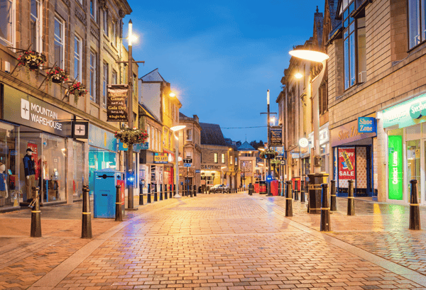 Storefront graphics show clearly in a high street in the UK. This is an effective way of marketing a business.