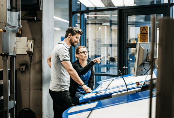 two people reviewing the programming options for a large scale print 