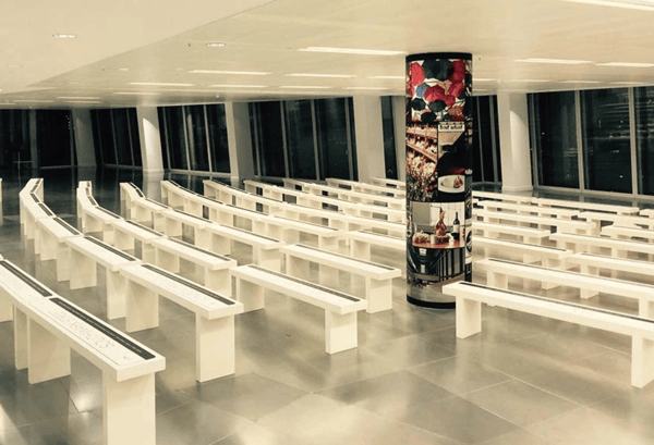 An interior wall graphic indoors shows a company's brand to an indoor seating area