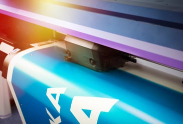Large format printer producing a high-resolution printed graphic for event signage.