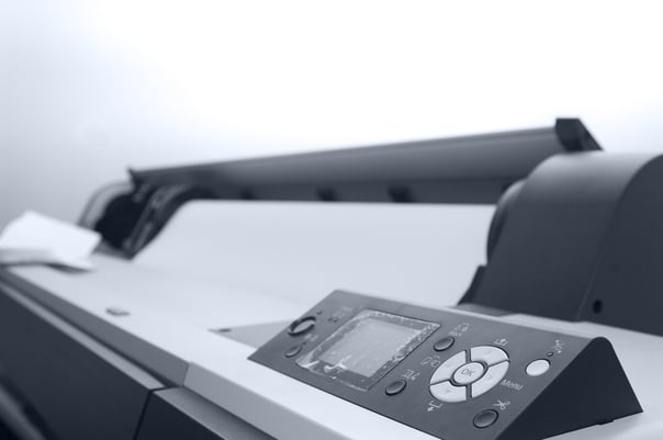 A black and white image of a large format printer 