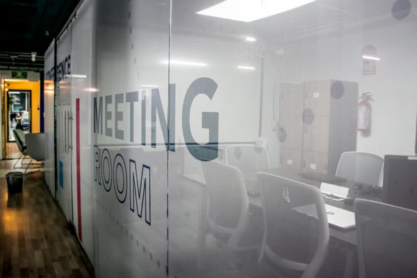 Modern office interior with branded wall graphics, showcasing large format printing solutions for workplace transformation.