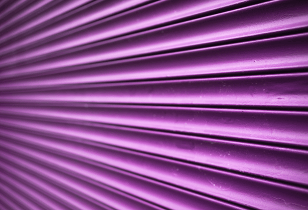 Purple shutters of a shop front to highlight the benefits of custom shutter graphics for businesses.  
