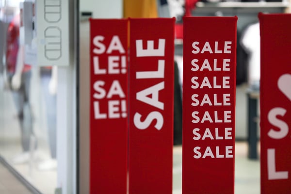 Bold red sale banners displayed outside retail shops created with high-impact large format printing.