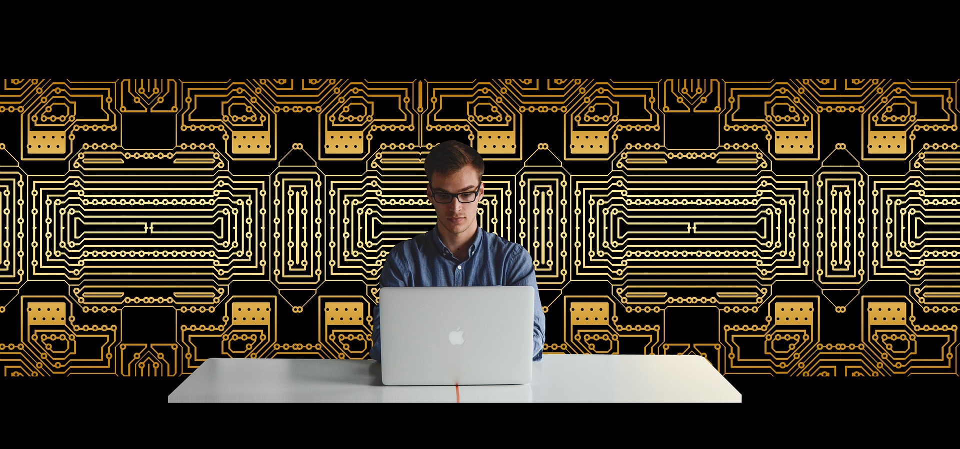 man working on laptop with decorative mural behind him showing the three uses for having a wall mural in your office