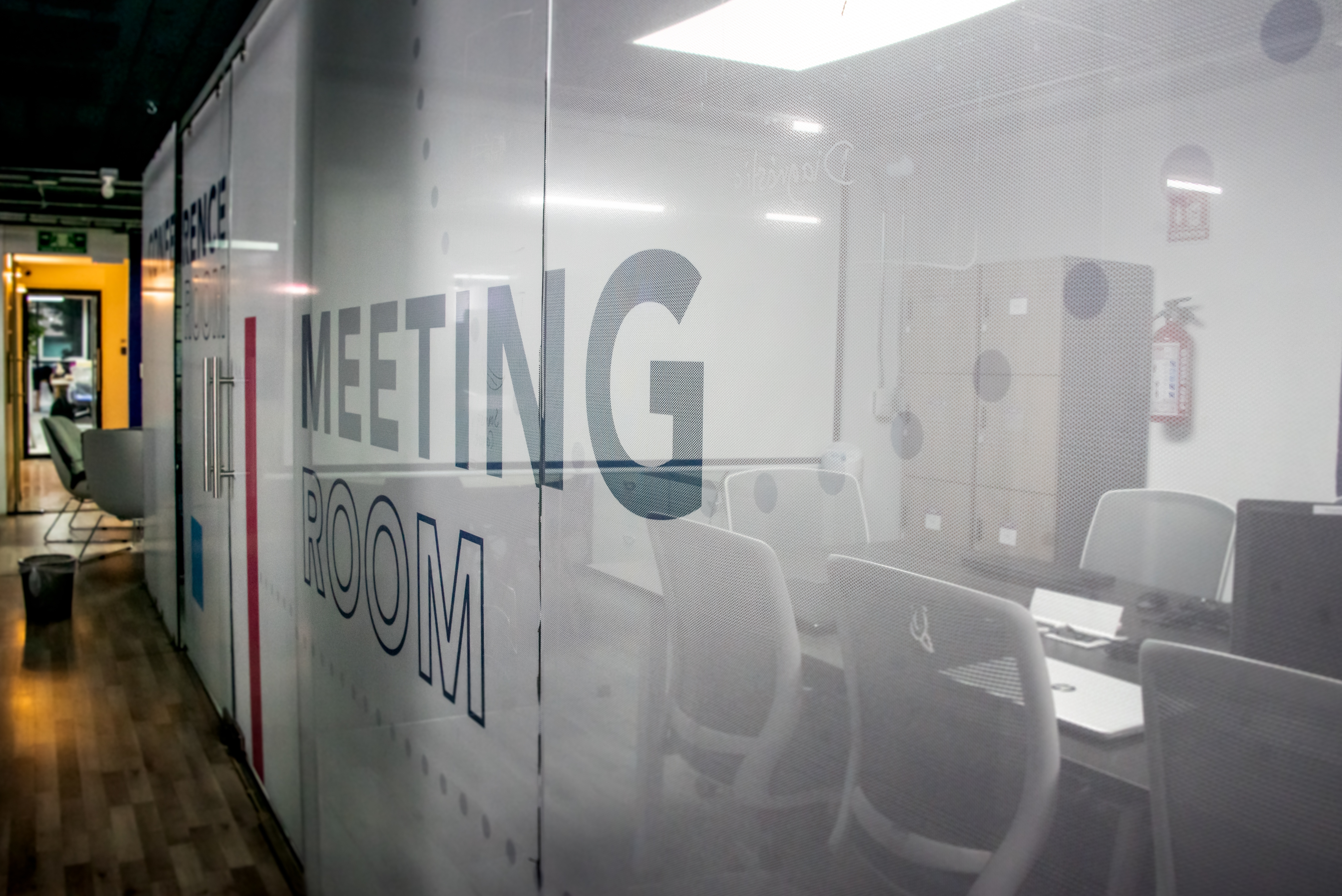 Modern office interior with branded wall graphics, showcasing large format printing solutions for workplace transformation.