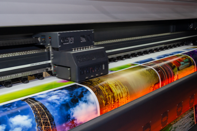 A large format printer that prints wide format images that will be used as a large wall graphic at a trade show. 